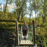 man crossing a bridge