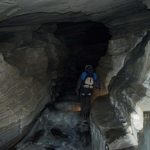 man walking in cave