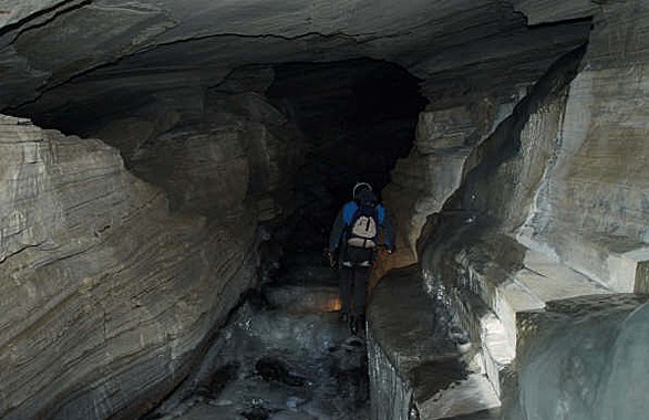 man walking in cave