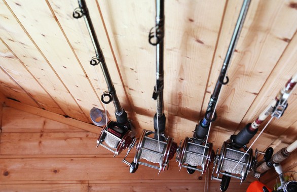 four fishing rods hanging in ceiling