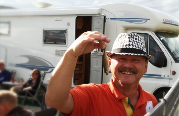 man holding small fish