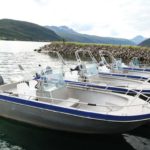 four boats docked to a pier