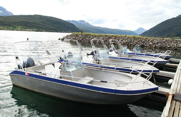 four boats docked to a pier