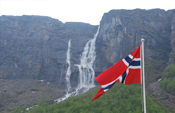Norwegian flag with mountain in background