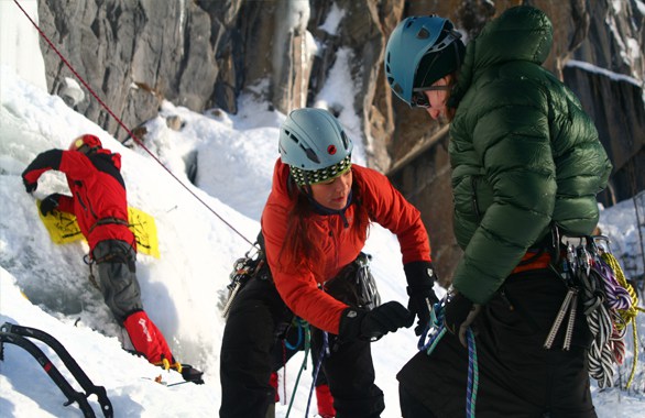 instructor helping man putting on gear