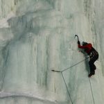 person climbing up ice wall