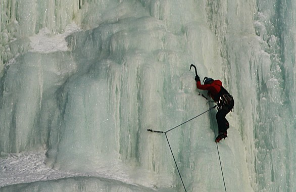 person climbing up ice wall