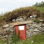 red door on a rock wall