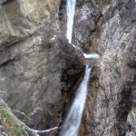 small waterfall on rock wall